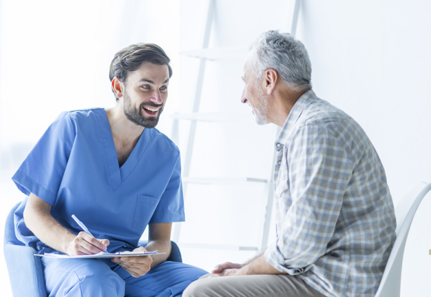 cheerful-doctor-talking-with-elderly-patient_23-2147896869